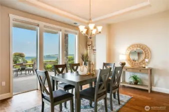 Graced with soaring windows and dual sliding doors, the formal dining room offers a luminous setting for elevated gatherings—seamlessly extending to the patio for effortless entertaining.