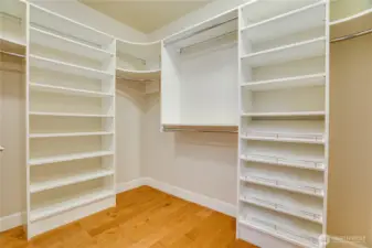 A generous walk-in closet with custom shelving and ample space—designed to keep your wardrobe beautifully organized and easily accessible.