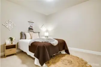 A spacious second bedroom with soft carpet underfoot—perfect for restful nights, stylish furnishings, or a personalized sanctuary.