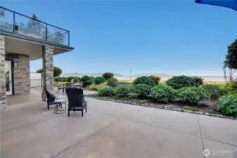 Step outside from the family room onto the grand patio and take in the breathtaking beauty of the Puget Sound, framed by the vibrant energy of Point Ruston's Waterwalk promenade. Floor-to-ceiling windows and glass doors in the family room, living room, dining area, and primary suite create a seamless connection to this expansive outdoor space—perfect for relaxing, entertaining, or simply soaking in the ever-changing coastal views from nearly every corner of the home.