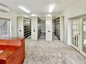 4403...Main floor library with French doors that open to the living room, desk area with more bookcases and territorial and water views.