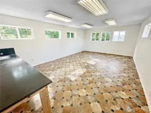 The detached garage features an upper floor office/craft room and/or storage space with utility sink.