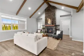Living Room featuring gas fireplace that is open to the kitchen and dining room