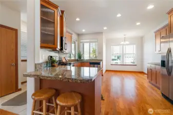 From the open living room, head up to the Peninsula Bar for a cup of coffee, a bite of breakfast, or a cozy place to catch up. The glass-front corner cabinet offers a beautiful way to showcase your favorite bowls, glassware, or decorative accents.