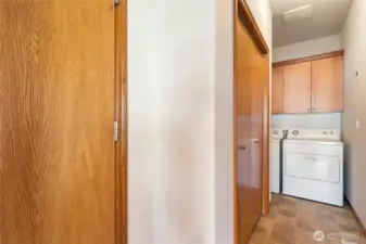 Laundry room area with door leading to the garage. To the right of photo is the entrance to kitchen.