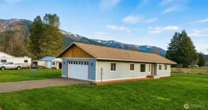 This 3-bed retreat, w/ 2 baths and an attached 2-car garage, blends rugged charm w/ modern quality.