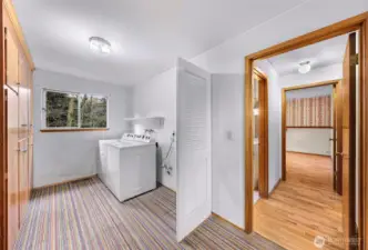 Huge laundry room with extra storage.
