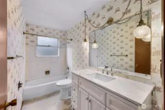 Large main bathroom with original light and updated vanity and toilet.