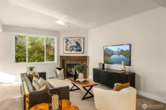 Cozy living room with gas fireplace overlooks the outdoor oasis.