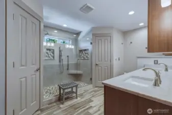 Primary bathroom with heated floors and two walk-in closets.