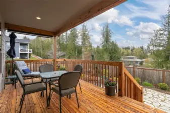 This covered cedar deck is so lovely for taking in the day or sunsets. It is south-facing and overlooks the lower lawn and patio. There is gas stubbed for a BBQ grill.