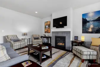 The living room is spacious and has a gas fireplace insert with tile surround and great walls for artwork.