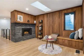 Perfect reading nook alongside gorgeous walnut paneling.