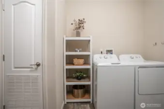 The utility room where the furnace is located behind louvered door. Plus washer and dryer convey with the sale of the home.