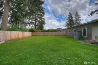 Another view of the backyard looking to the South. Garden storage is included, and on the right you will see the back door entry with a pet entry.