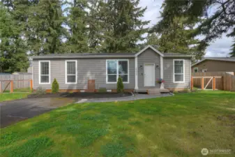 Another view of the large front yard with perimeter fencing and cross fencing enclosing the entire backyard.