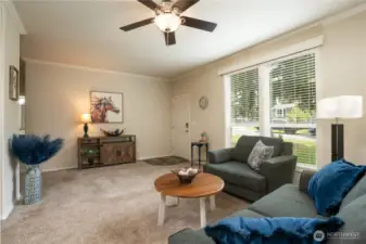 Plenty of room for you to relax in this spacious living room, plus a ceiling fan to keep nice air flow in this area, and  on the left is the hall which leads to the two additional bedrooms.