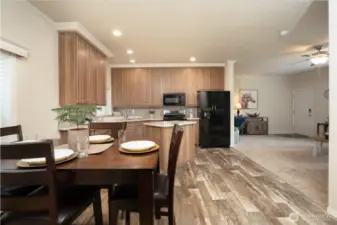 View of dining area flowing into kitchen and living room.