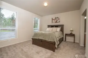The primary en suite, the bedroom is spacious with plenty of room for your larger furniture and on the right is the doorway to the 3/4 bathroom.