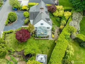 Large, level, manicured lot with mature landscaping and fruit trees.