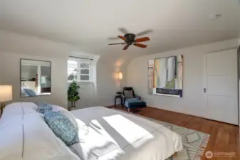 Huge primary bedroom with walk-in closet, stunning view, and glowing natural light.