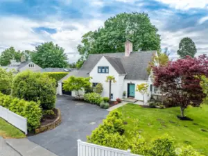 Stately manicured lot with circular driveway.
