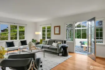 Sun-filled expansive living room with wood burning fireplace.