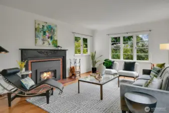 Sun-filled expansive living room with wood burning fireplace.