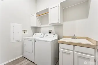 Laudry room w/ sink. Washer and dryer stay.