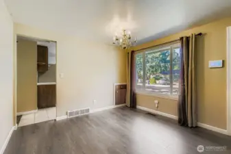 Dining room with a chandelier and small built-in for tablecloths, napkins, and candlesticks.