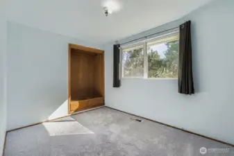 This second bedroom on the street level is down the hall from the large corner bedroom and overlooks the backyard.