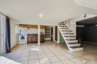 The lower level kitchen is on the north side of the house and opens via a sliding glass door to the back yard. There is a full bath on the other side of the kitchen wall and a utility room to the back right in this photo.