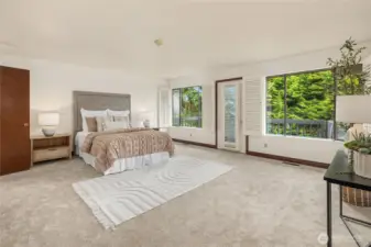 The primary bedroom is enormous. The door leads to a sizable deck.