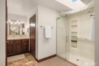 The primary bath has two walk-in closets, two vanities, and a walk-in shower.