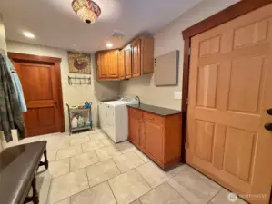 Spacious laundry room goes into garage.