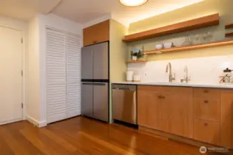 Streamlined Counters & thoughtful under-cabinet lighting. Concealed Laundry area w/storage behind louvered doors.