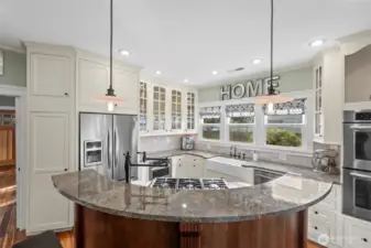 Half moon island with six burner gas range and built in pot filler makes cooking convenient and highly enjoyable.