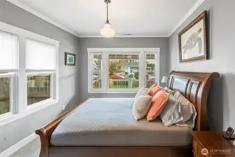 The front bedroom is used as the primary bedroom. A room surrounded by windows but also with privacy in mind. The laminated and sound transmission control window package keeps you looking out but not easy to look in.