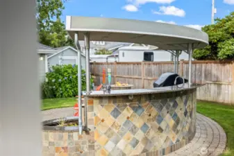 The outdoor kitchen features a two tap keg, soda stream, outdoor fridge and ice maker and a infrared lynx grill.