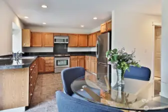Propane stovetop/range. There's space for a center island, too! Open door at the far right edge of photo is to the laundry and utility room. Across from the laundry room is a half bath. Door to the garage is just beyond the right edge of the photo.