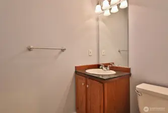 Half bath across from the laundry room and adjacent to the door that leads to your garage.
