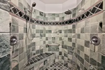 Double headed shower and a bench to sit.