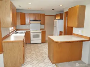 Kitchen w/ eating bar and walk-in pantry/laundry room.