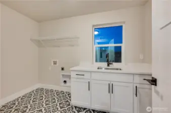 Laundry room complete with sink and cabinets
