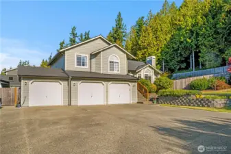 Beautifully maintained home with striking curb appeal, a three-car garage, and a spacious driveway. Surrounded by mature trees and thoughtful landscaping, this property offers both privacy and charm in a peaceful neighborhood setting.