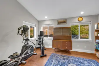 Versatile space with large windows, hardwood floors, and room for fitness equipment. Perfect for a home gym, hobby area, or quiet retreat.