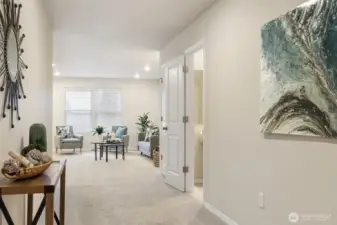 Welcoming entrance from the front door, with half bath to the right.