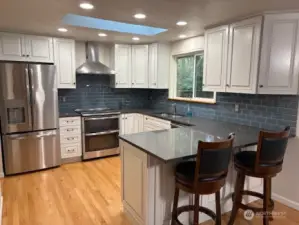 quartz countertops, newer apppliances w/pantry around the corner