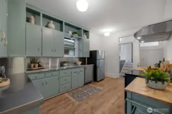 The wall and door at the end of the kitchen was put in to separate the back space into a more private apartment but could be opened up again for the back den space to open to the kitchen.