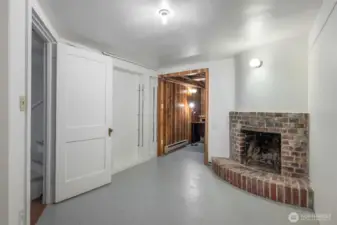 Another space in the lower level- non-working fireplace and utility room with water heater.
